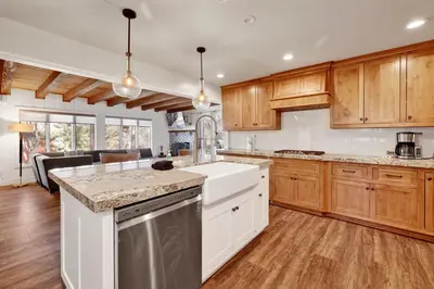 a kitchen with wooden cabinets and white appliances at Splash mountain #1904 in Big Bear Lake