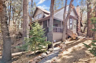 a house with a porch in the woods at Splash mountain #1904 in Big Bear Lake