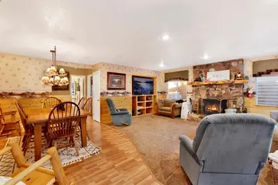 a living room with a table and a fireplace at Big bear happy place #2421 in Big Bear Lake
