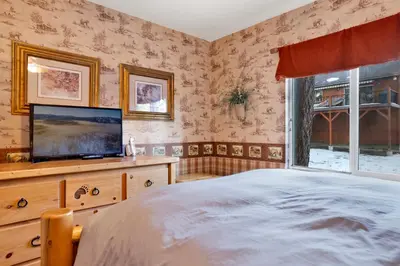 a bedroom with a bed and a flat screen tv at Big bear happy place #2421 in Big Bear Lake