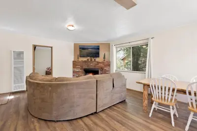 a living room with a large couch and a table at Twin pines #111 in Big Bear Lake