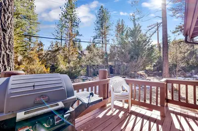 a grill on a deck with a chair on it at Restmoore #2425 in Big Bear Lake