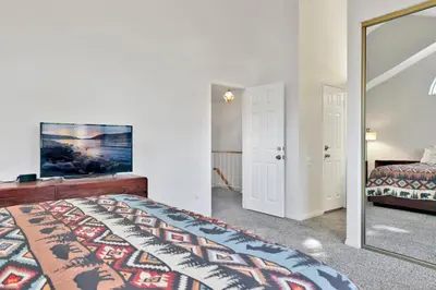 a bedroom with a bed and a mirror at Restmoore #2425 in Big Bear Lake