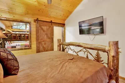 a bedroom with a bed and a tv on a wall at Luxury lodge #1888 in Big Bear Lake