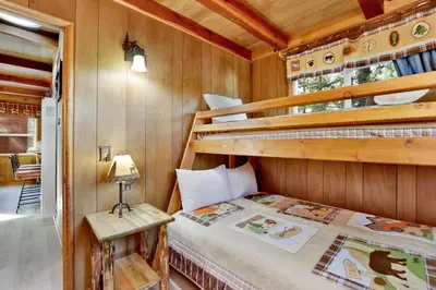 a bedroom with two bunk beds in a cabin at Kozy cabin #2386 in Big Bear Lake