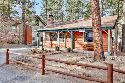a wooden cabin with a fence in front of it at Kozy cabin #2386 in Big Bear Lake