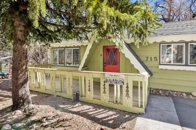 a house with a front porch with a red door at Marin getaway #2013 in Big Bear Lake