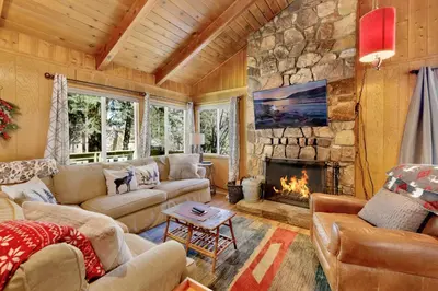 a living room with couches and a stone fireplace at Marin getaway #2013 in Big Bear Lake