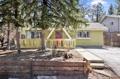 a yellow house with a fence in front of it at Marin getaway #2013 in Big Bear Lake