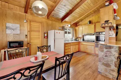 a kitchen and dining room with a table and chairs at Marin getaway #2013 in Big Bear Lake