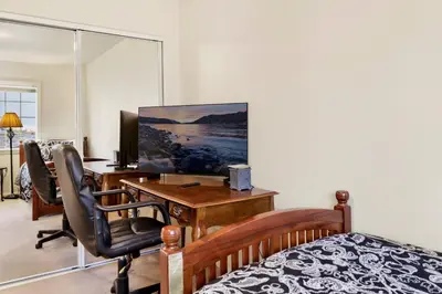 a bedroom with a desk and a bed with a computer at Mockingbird getaway #2091 in Big Bear Lake