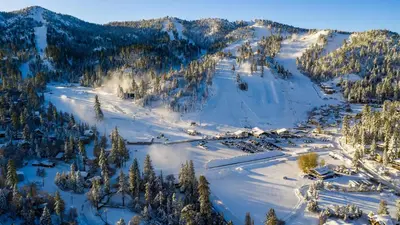 an aerial view of a snow covered mountain with trees at Smith chalet at snow summit #2278 in Big Bear Lake