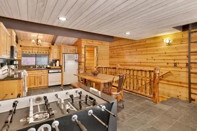a kitchen with wooden walls and a balcony at Smith chalet at snow summit #2278 in Big Bear Lake