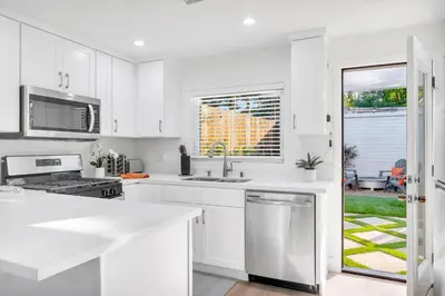 a white kitchen with a sink and a window at Cozy Cottage, Brand New, fully Private, walk to Everything in Thousand Oaks