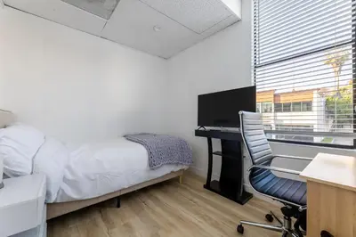 a bedroom with a desk and a bed and a chair at Free Parking Pasadena Room near Convention Center & Caltech in Pasadena