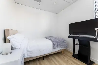 a bedroom with a bed and a flat screen tv at Free Parking Pasadena Room near Convention Center & Caltech in Pasadena