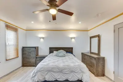 a bedroom with a bed and a ceiling fan at 1 Mi to Melrose Ave and Grove! Upscale LA Retreat in Los Angeles