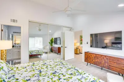 a bedroom with a bed and a large screen tv at Idyllic Tustin Home with Private Patio and Grill in Tustin