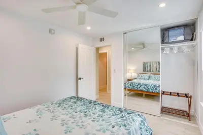 a bedroom with a bed and a mirror at Idyllic Tustin Home with Private Patio and Grill in Tustin