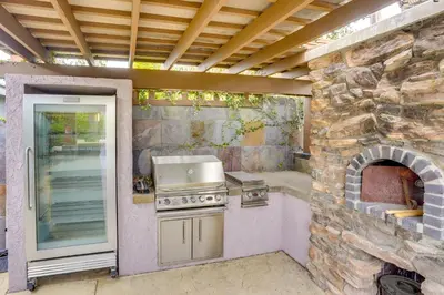 a outdoor kitchen with a stove and an oven at Lovely Tustin Home with Outdoor Kitchen 3 Mi to Zoo in Tustin