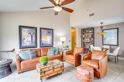 a living room with leather furniture and a ceiling fan at Lovely Tustin Home with Outdoor Kitchen 3 Mi to Zoo in Tustin