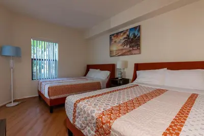 a hotel room with two beds and a window at Urban Haven at Orsini in Los Angeles
