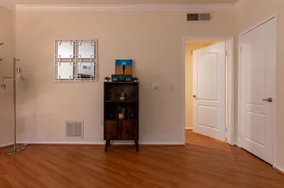 an empty room with a table and a mirror on the wall at Urban Haven at Orsini in Los Angeles
