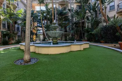 a courtyard with a fountain in the middle of a building at Urban Haven at Orsini in Los Angeles