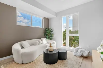 a living room with a white couch and a table at Luxury & Modern Apt by the Grove in Los Angeles