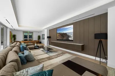a living room with a large couch and a tv at Brand New Modern & Luxury Residence in DTLA in Los Angeles