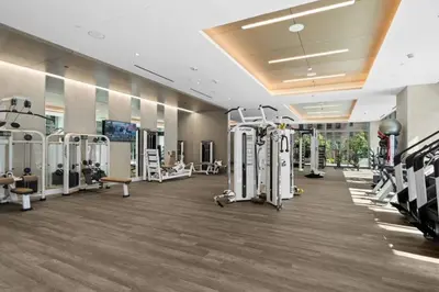 a gym with treadmills and machines in a room at Epitome of Luxury Condo in DTLA in Los Angeles