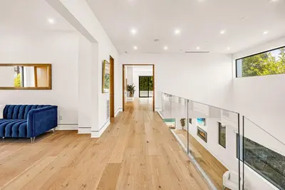 a hallway of a house with a blue couch at Luxurious Retreat - Modern House with Pool in Los Angeles