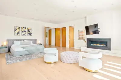 a bedroom with a bed and a fireplace at Luxurious Retreat - Modern House with Pool in Los Angeles