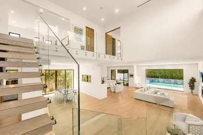 a large living room with a staircase and a couch at Luxurious Retreat - Modern House with Pool in Los Angeles