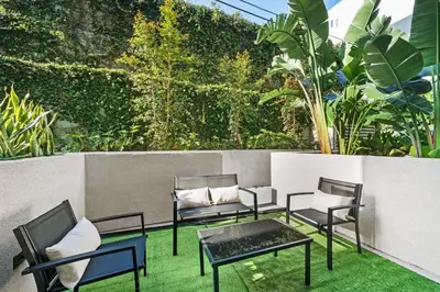 a group of chairs and tables on a patio at Versatile Luxury Oasis in Los Angeles