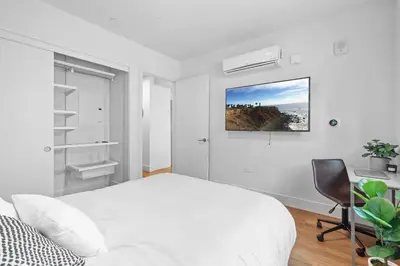 a white bedroom with a bed and a desk at Versatile Luxury Oasis in Los Angeles