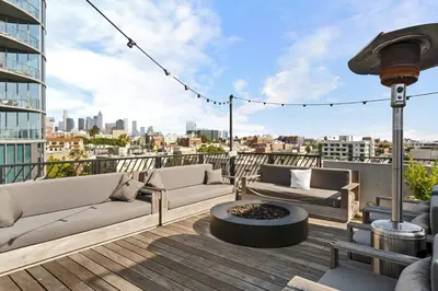 a balcony with couches and a fire pit on a building at Versatile Luxury Oasis in Los Angeles