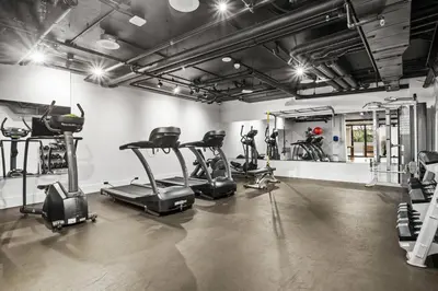 a gym with treadmills and ellipticals in a room at Versatile Luxury Oasis in Los Angeles