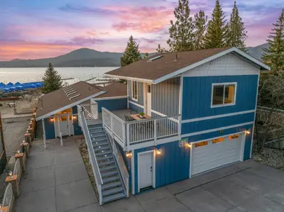 a blue tiny house with a deck and stairs at Modern Lakefront Dream Home Steps from Big Bear Village in Big Bear Lake