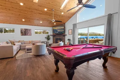 a living room with a pool table in it at Modern Lakefront Dream Home Steps from Big Bear Village in Big Bear Lake