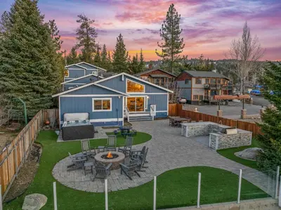 a backyard with a fire pit and a house at Modern Lakefront Dream Home Steps from Big Bear Village in Big Bear Lake