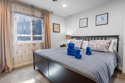 a bedroom with a large bed with blue stuffed animals on it at Modern Lakefront Dream Home Steps from Big Bear Village in Big Bear Lake