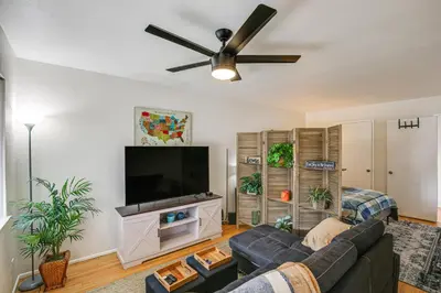 a living room with a couch and a flat screen tv at 2 Mi to Ocean! Executive-Style Oasis in Long Beach in Long Beach