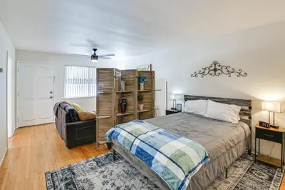 a bedroom with a bed and a chair at 2 Mi to Ocean! Executive-Style Oasis in Long Beach in Long Beach