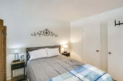 a bedroom with a bed and two night stands at 2 Mi to Ocean! Executive-Style Oasis in Long Beach in Long Beach