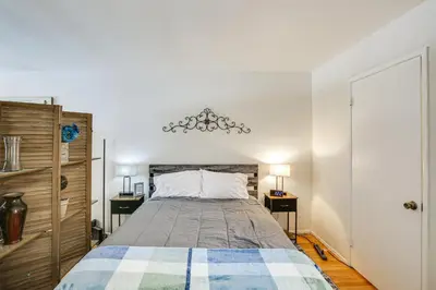 a bedroom with a bed and two night stands at 2 Mi to Ocean! Executive-Style Oasis in Long Beach in Long Beach