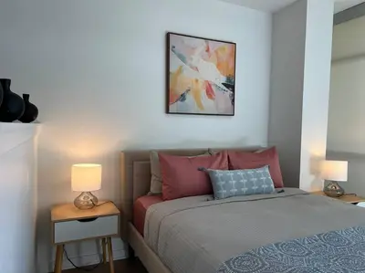 a bedroom with a bed and two lamps on tables at Fortuna-Seaside Retreat in Santa Monica, steps to the beach, free parking in Los Angeles