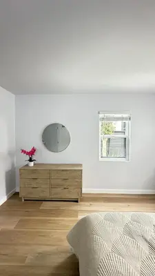 a white room with a dresser and a mirror at Modern 2BR Stylish & Cozy Unit in Los Angeles