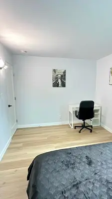 a bedroom with a bed and a desk and a chair at Modern 2BR Stylish & Cozy Unit in Los Angeles