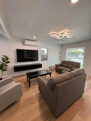 a living room with a couch and a flat screen tv at Modern 2BR Stylish & Cozy Unit in Los Angeles